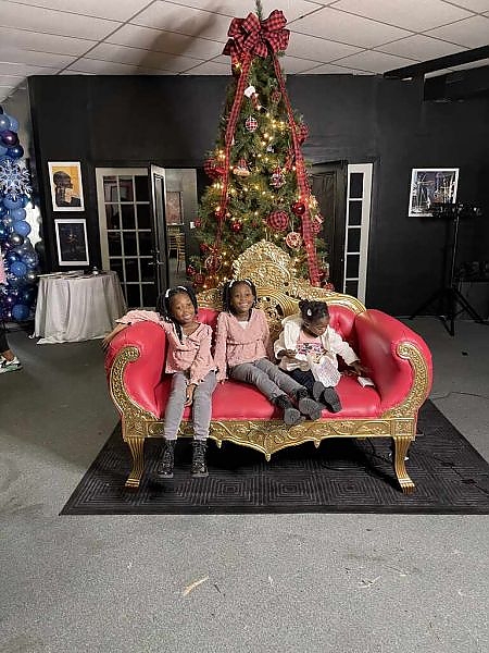  Kids sitting in chair in front of tree